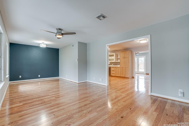 spare room featuring ceiling fan and light wood-type flooring