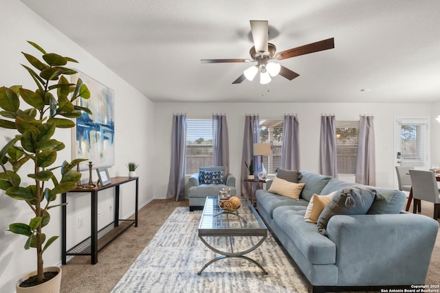 living room featuring light carpet and ceiling fan