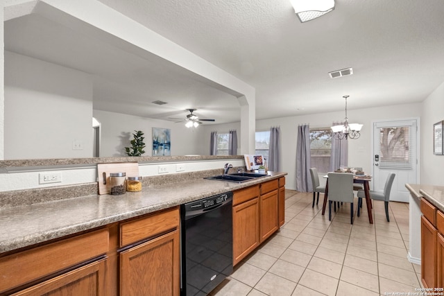 kitchen featuring ceiling fan with notable chandelier, pendant lighting, dishwasher, sink, and light tile patterned floors