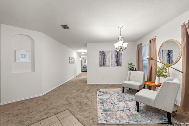 sitting room featuring light carpet, a notable chandelier, and lofted ceiling