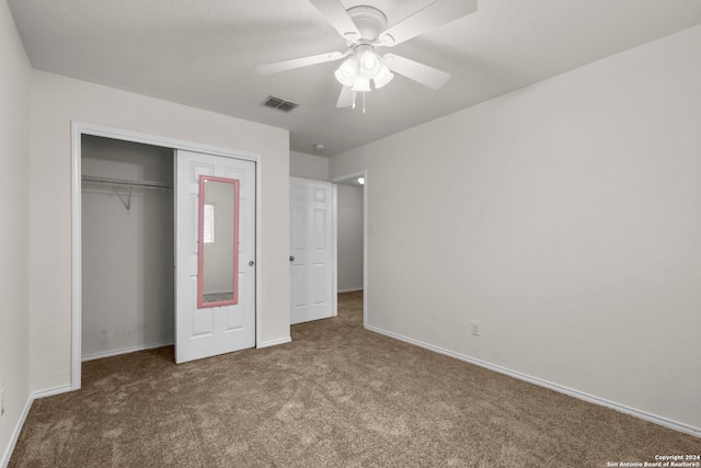 unfurnished bedroom with a closet, ceiling fan, and carpet flooring