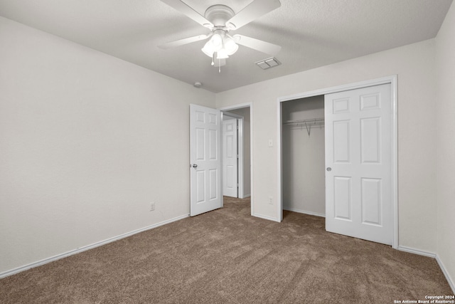 unfurnished bedroom with carpet, ceiling fan, and a closet