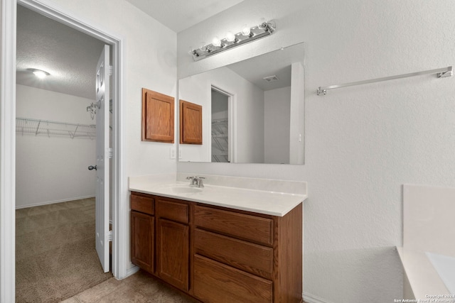 bathroom featuring vanity and a textured ceiling