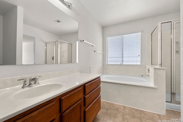 bathroom featuring vanity and shower with separate bathtub