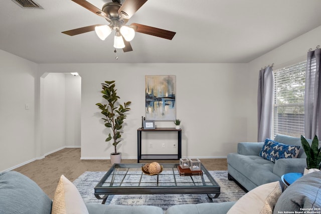 carpeted living room featuring ceiling fan