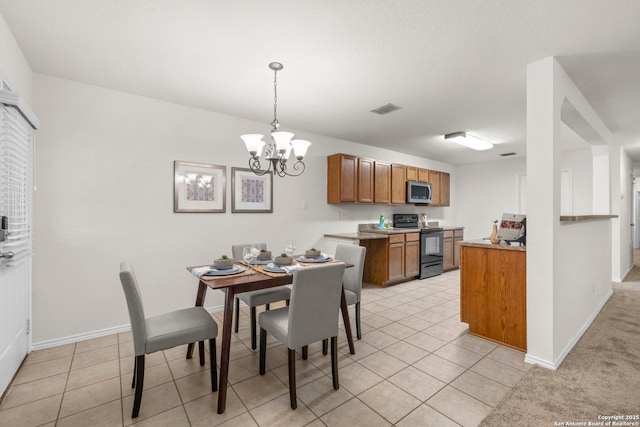 tiled dining space featuring a chandelier