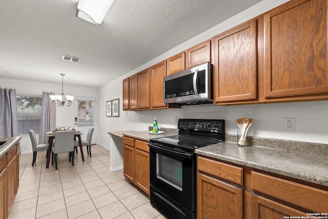 kitchen with pendant lighting, black electric range oven, light tile patterned floors, a notable chandelier, and a textured ceiling