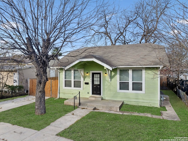 bungalow-style house featuring a front yard