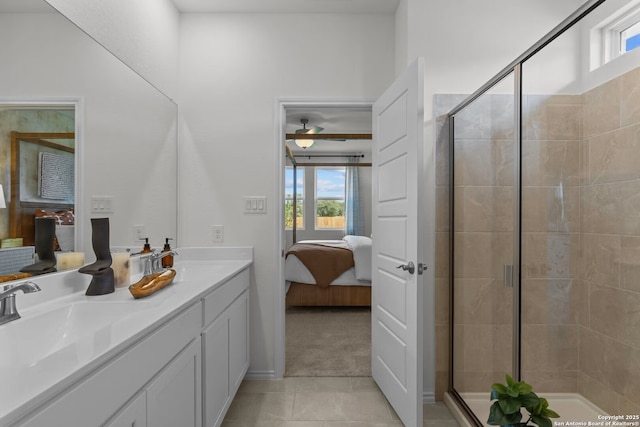 bathroom with a shower with shower door, tile patterned floors, and plenty of natural light