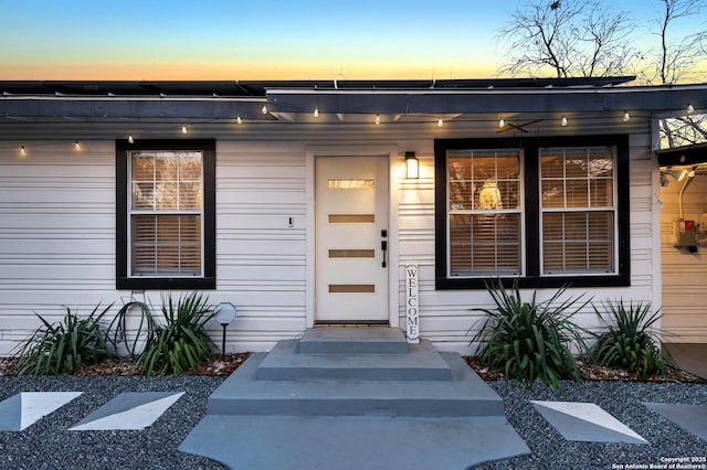 view of exterior entry at dusk