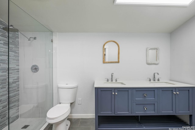 bathroom with tiled shower, vanity, toilet, and tile patterned flooring