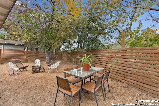 view of patio with a fire pit