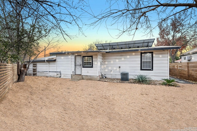 view of back house at dusk