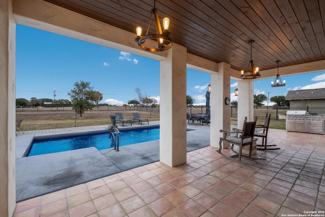 view of pool featuring a grill and a patio area