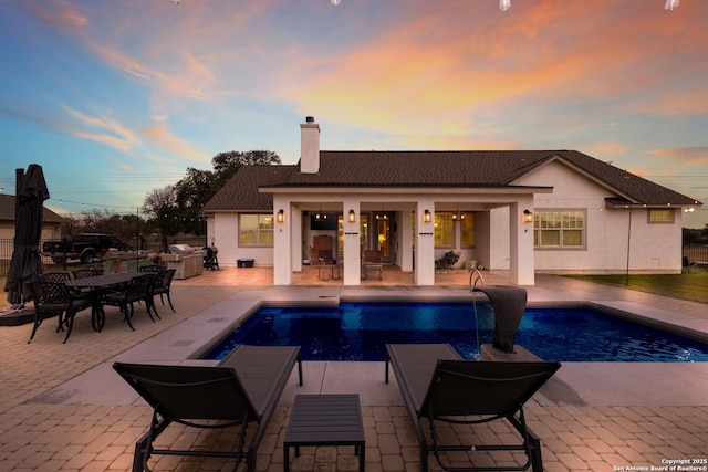 view of swimming pool with a patio area and an outdoor structure