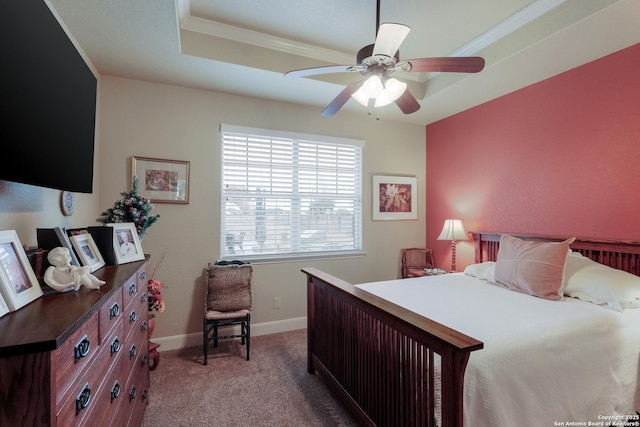 carpeted bedroom with ornamental molding, ceiling fan, and a tray ceiling