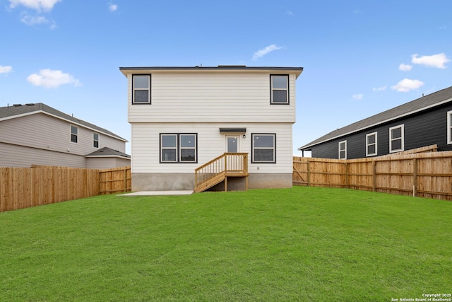 back of property featuring a lawn and a fenced backyard