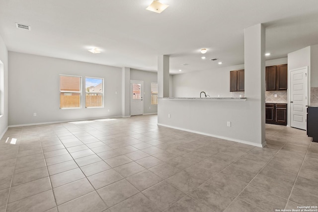 unfurnished living room with recessed lighting, baseboards, visible vents, and light tile patterned flooring