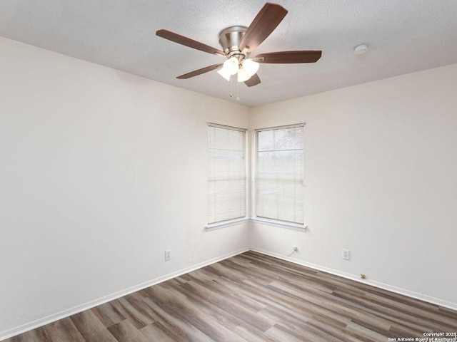 unfurnished room with dark hardwood / wood-style flooring, ceiling fan, and a textured ceiling