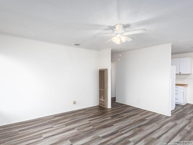 unfurnished room featuring wood-type flooring, crown molding, ceiling fan, and a textured ceiling