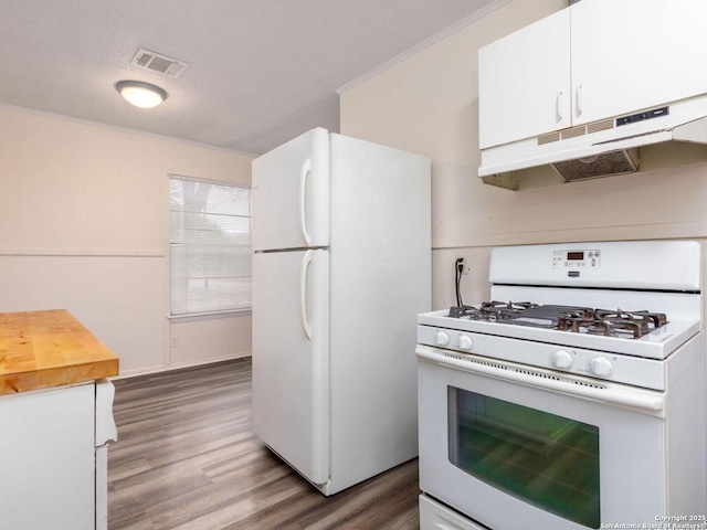 kitchen with dark wood-type flooring, a textured ceiling, ornamental molding, white appliances, and white cabinets