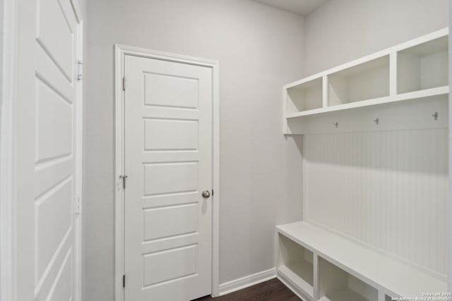 mudroom featuring baseboards and dark wood finished floors