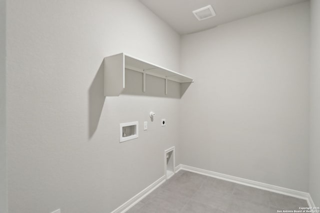 washroom with baseboards, hookup for an electric dryer, gas dryer hookup, laundry area, and washer hookup