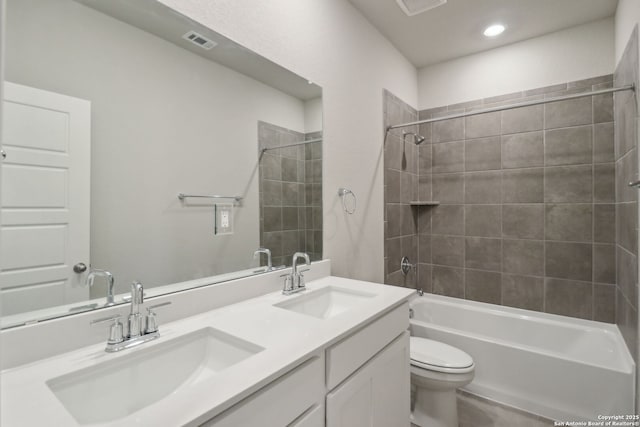 full bathroom featuring shower / tub combination, toilet, visible vents, and a sink