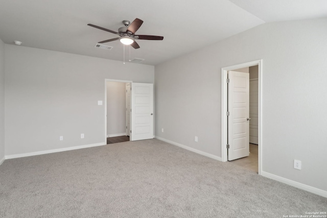 unfurnished bedroom with visible vents, baseboards, carpet, lofted ceiling, and ceiling fan