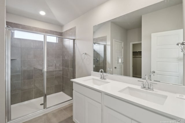 bathroom featuring a sink, a shower stall, and tile patterned floors