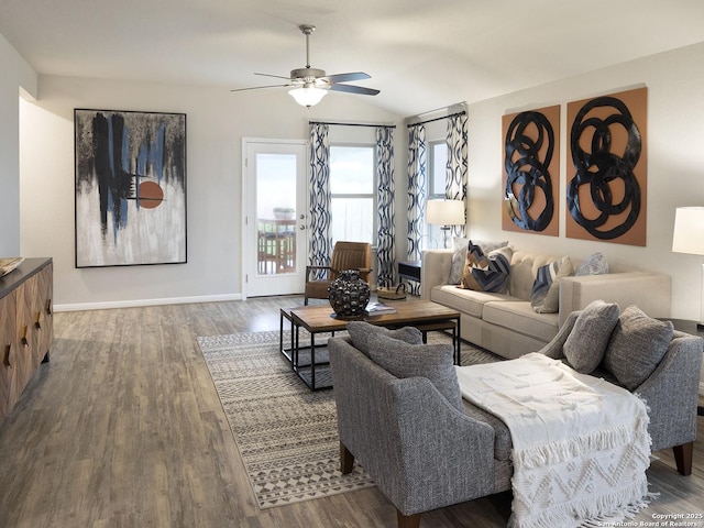 living area with vaulted ceiling, ceiling fan, baseboards, and wood finished floors