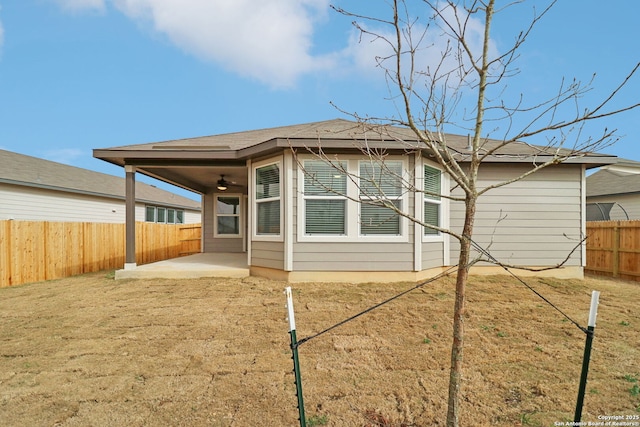 rear view of property featuring a ceiling fan, a patio area, and a fenced backyard