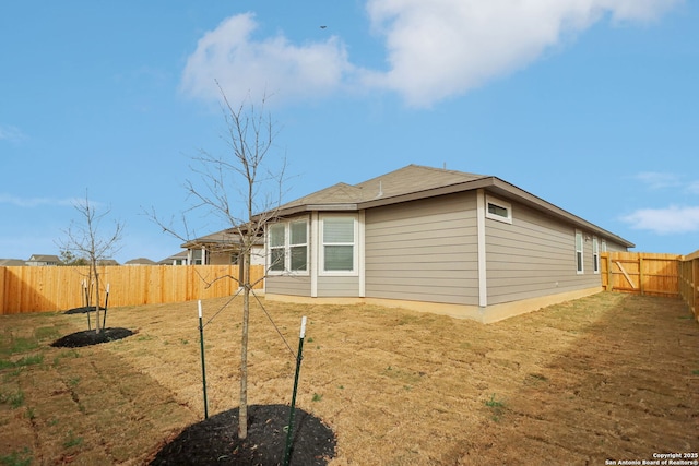 rear view of property with a fenced backyard