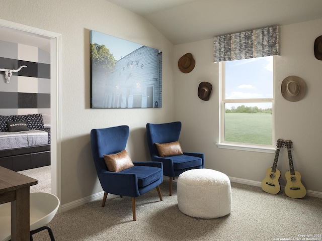 living area featuring baseboards, carpet, and vaulted ceiling