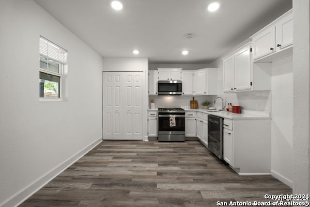 kitchen with sink, stainless steel appliances, dark hardwood / wood-style floors, tasteful backsplash, and white cabinets