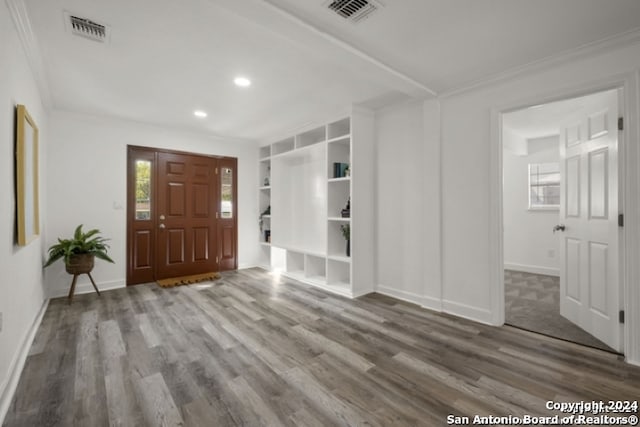 entrance foyer featuring crown molding and wood-type flooring