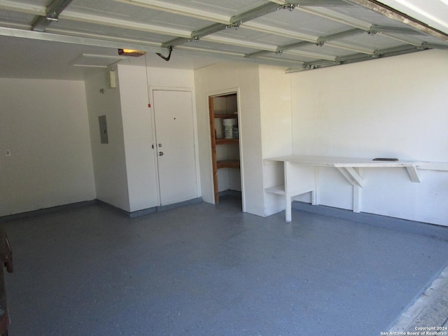 garage featuring a garage door opener and electric panel