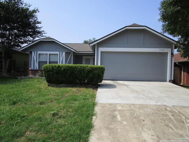 ranch-style home with a garage and a front yard