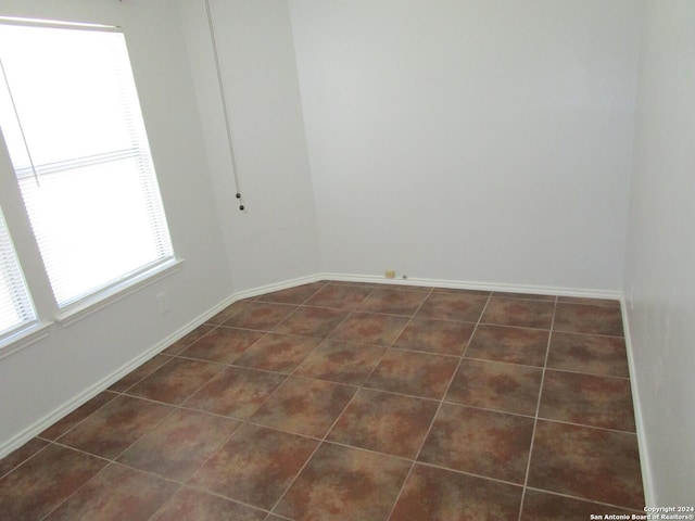 tiled empty room with plenty of natural light