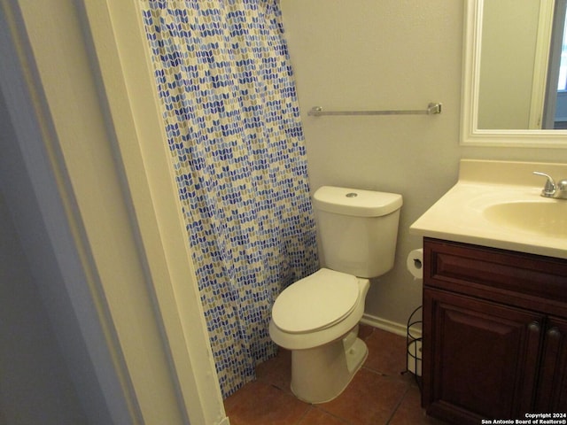 bathroom featuring tile patterned floors, vanity, and toilet