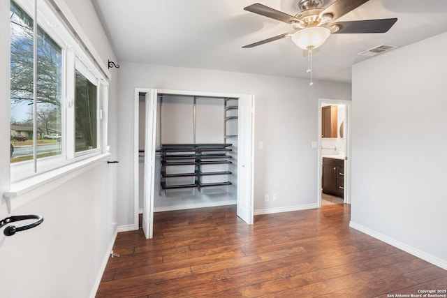 interior space with dark hardwood / wood-style floors and ceiling fan