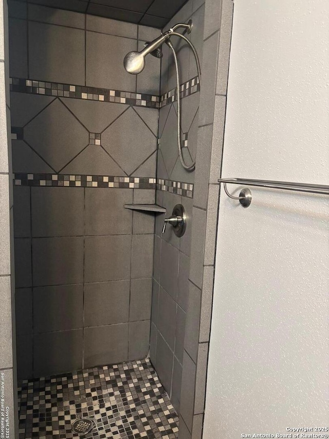 bathroom with tiled shower