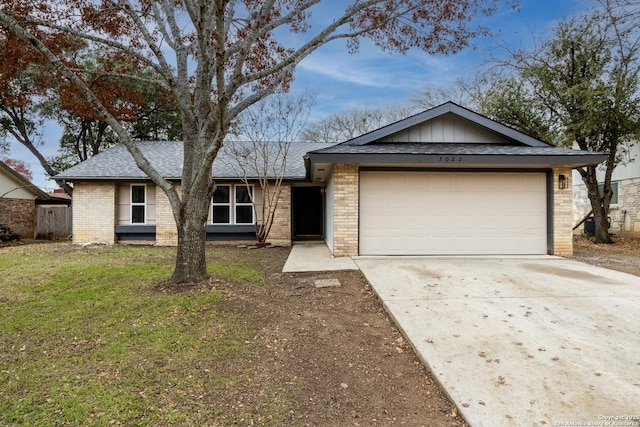 single story home with a garage and a front lawn