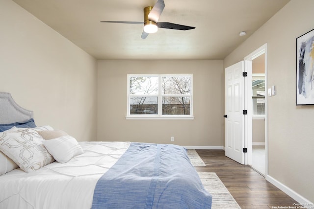 bedroom with ceiling fan and dark hardwood / wood-style floors