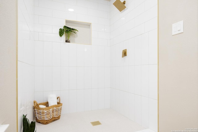 bathroom with a tile shower