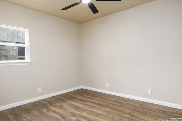 unfurnished room with dark hardwood / wood-style floors and ceiling fan