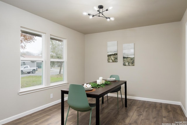 office featuring a notable chandelier, dark wood-type flooring, and plenty of natural light