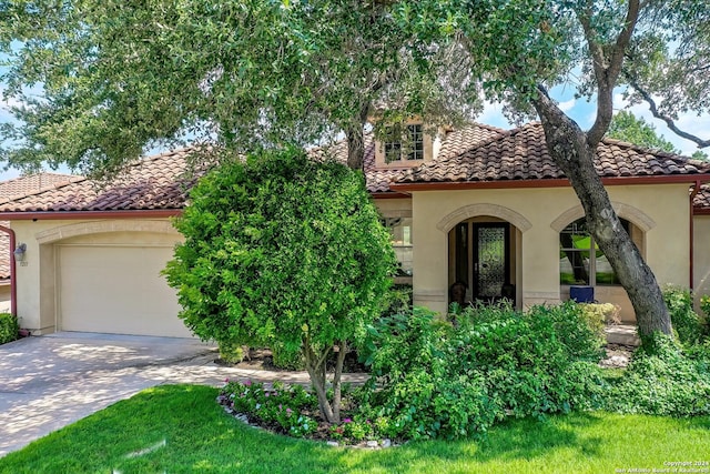 mediterranean / spanish home with a garage