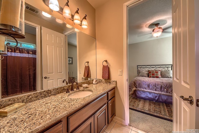 bathroom featuring ceiling fan, vanity, and tile patterned flooring