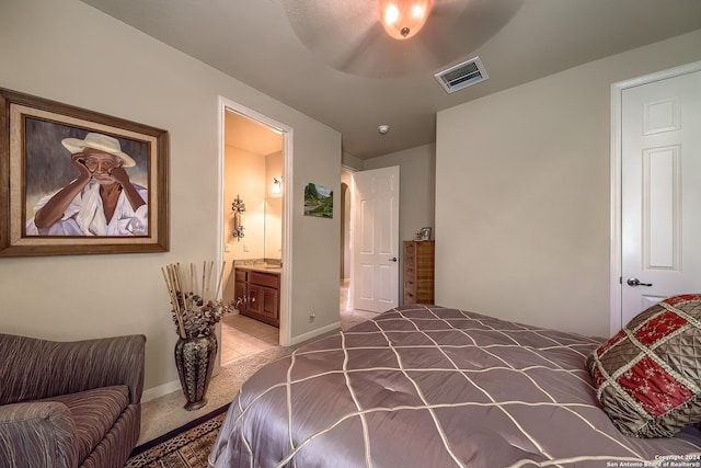 bedroom with ceiling fan, ensuite bath, and carpet floors